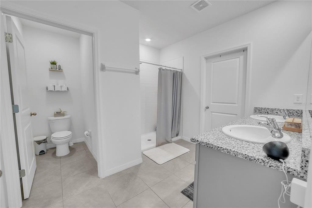 8237 Juning Cove Wesley Chapel, FL 33545 - Photo 35 of 59 a bathroom with a sink toilet and shower