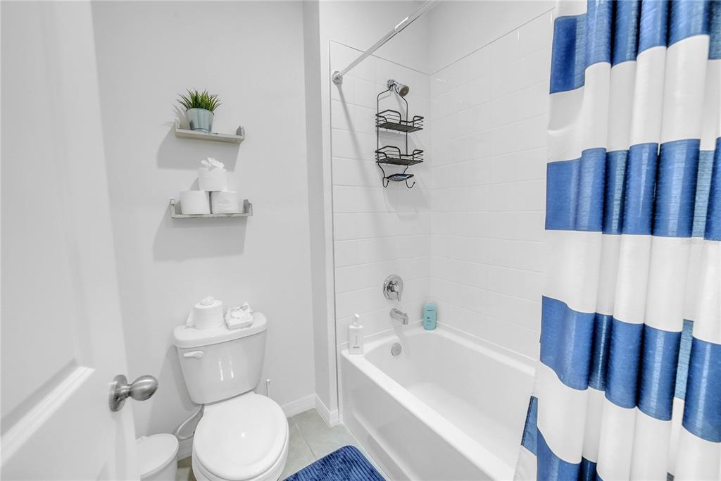 8237 Juning Cove Wesley Chapel, FL 33545 - Photo 48 of 59 a white toilet sitting next to a bathroom sink