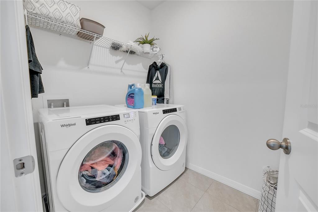 8237 Juning Cove Wesley Chapel, FL 33545 - Photo 49 of 59 a utility room with dryer and washer