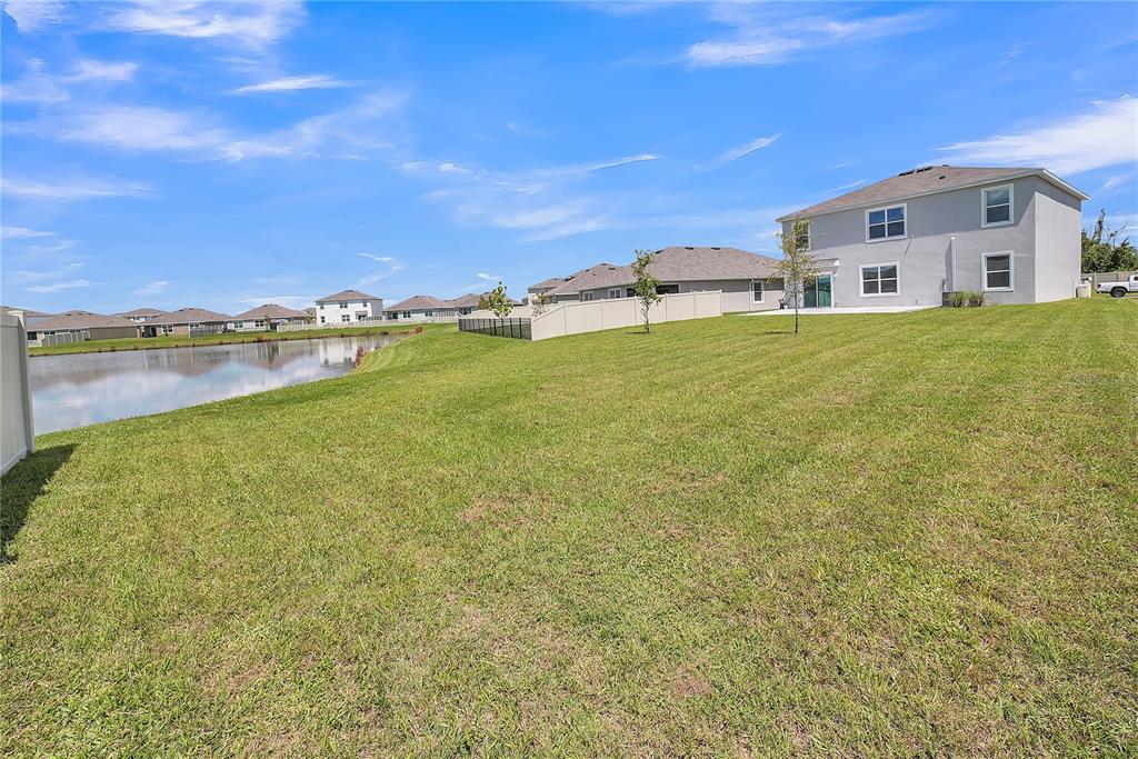 8237 Juning Cove Wesley Chapel, FL 33545 - Photo 54 of 59 a front view of a house with a yard