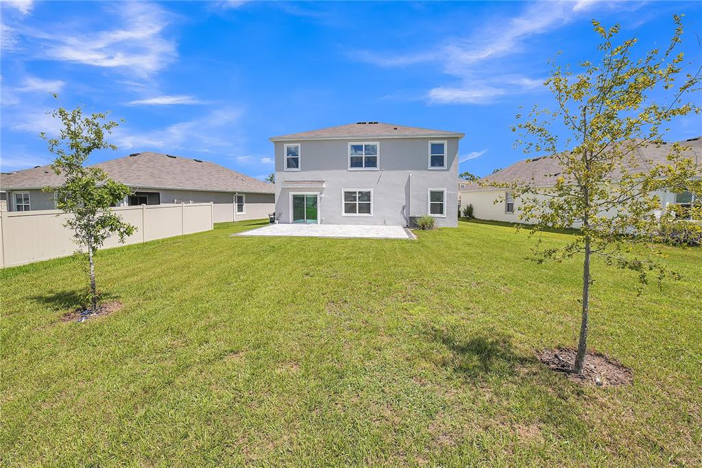 8237 Juning Cove Wesley Chapel, FL 33545 - Photo 56 of 59 a front view of a house with a yard