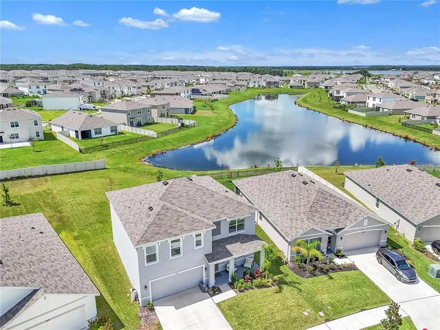 a aerial view of a house with swimming pool and a yard