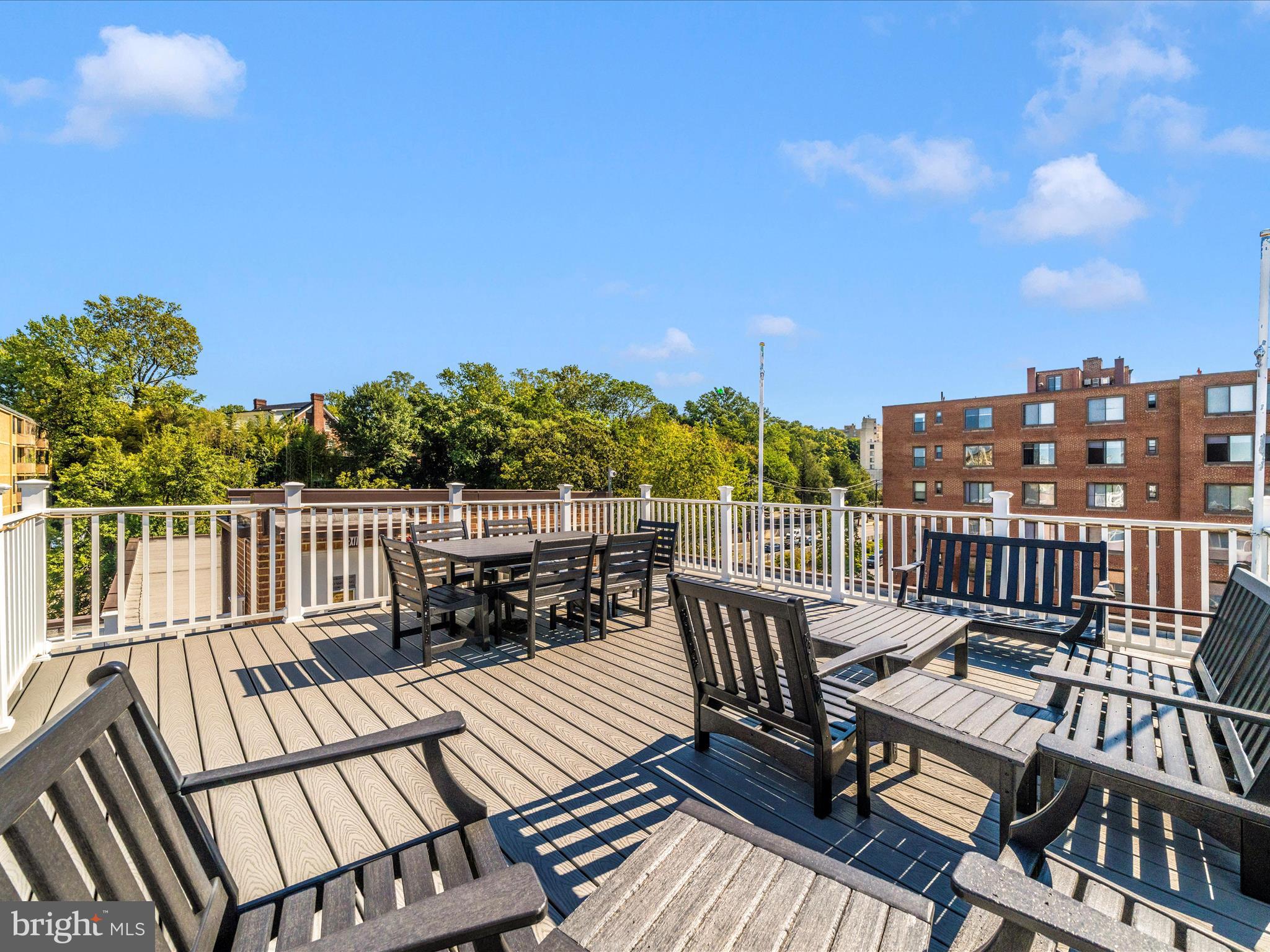 3900 Tunlaw Road Northwest, Unit 613 Washington, DC 20007 - Photo 27 of 31 a view of a balcony with wooden benches