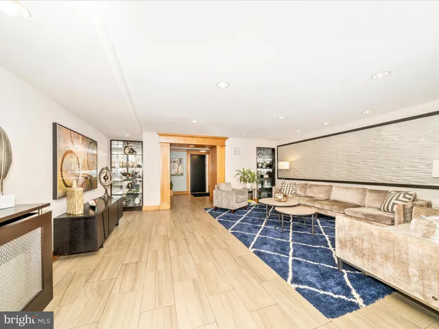 a spacious bedroom with a bed and wooden floor