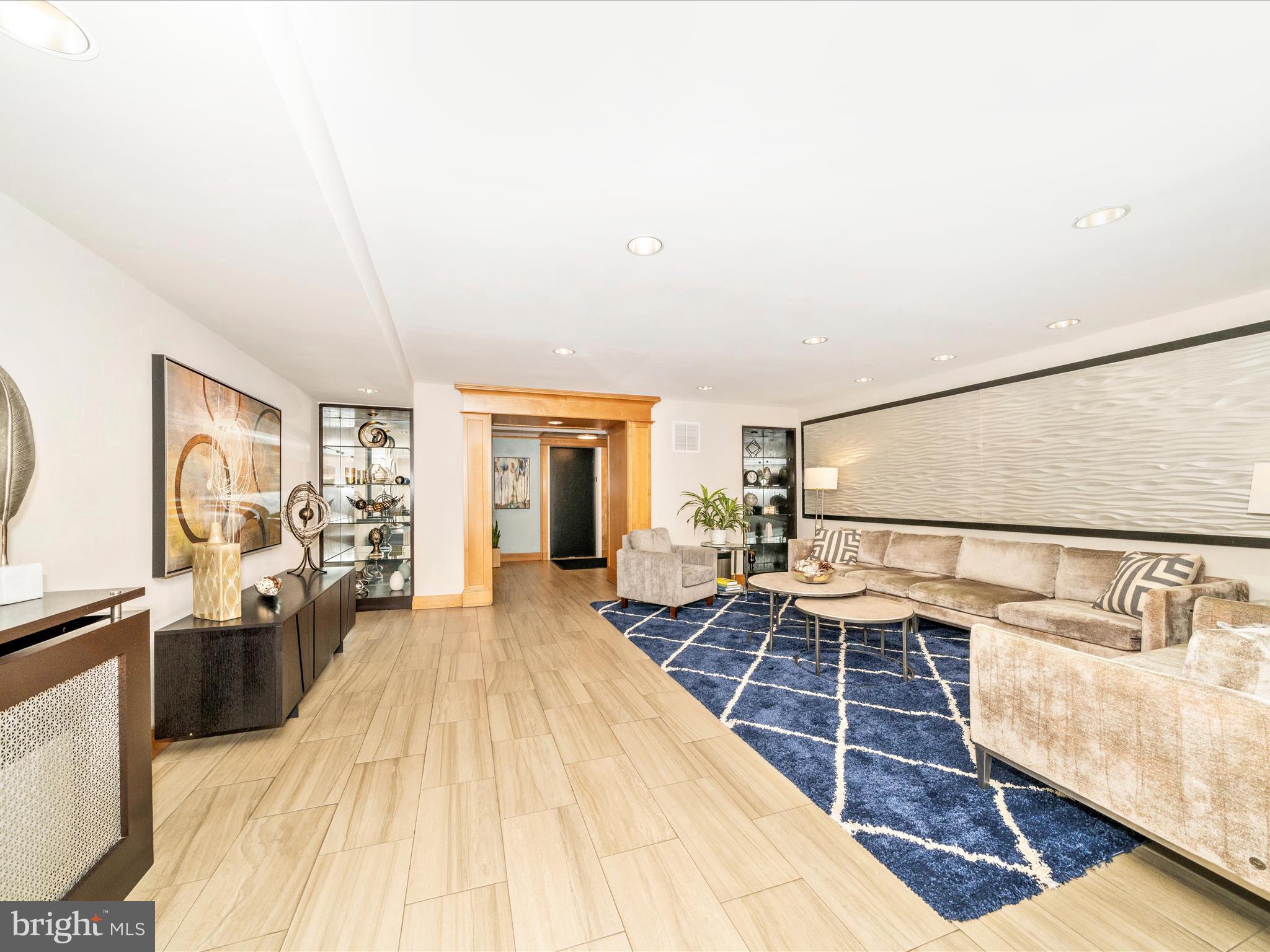 3900 Tunlaw Road Northwest, Unit 613 Washington, DC 20007 - Photo 3 of 31 a spacious bedroom with a bed and wooden floor