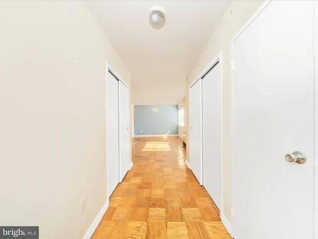 a view of a hallway with white walls