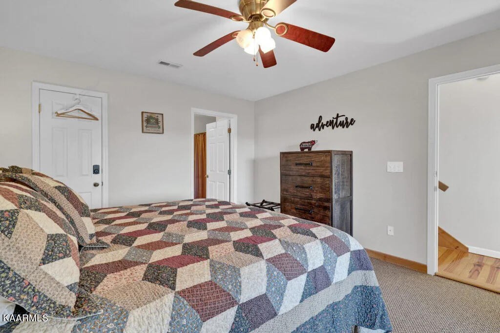 3514 Jakes Ridge Sevierville, TN 37862 - Photo 14 of 28 a bedroom with a bed and a chandelier