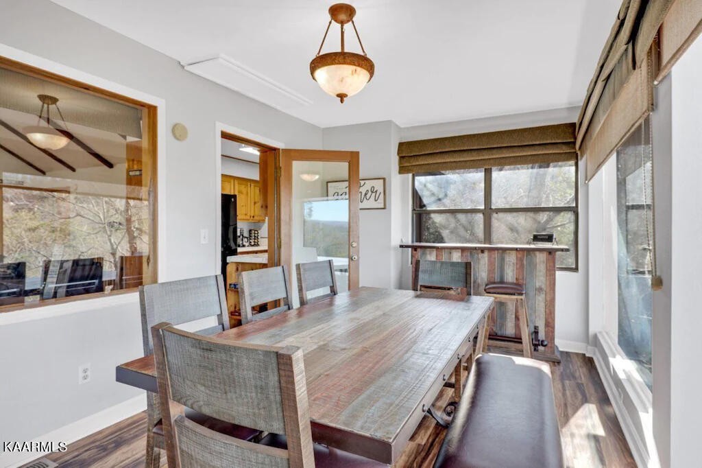 3514 Jakes Ridge Sevierville, TN 37862 - Photo 8 of 28 a dining room with wooden floor a chandelier a wooden table and chairs