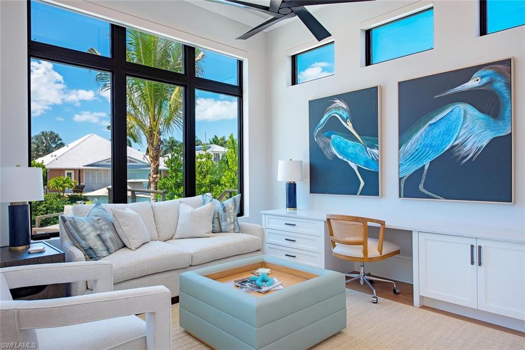 1456 Curlew Avenue Naples, FL 34102 - Photo 14 of 38 a living room with furniture and a floor to ceiling window