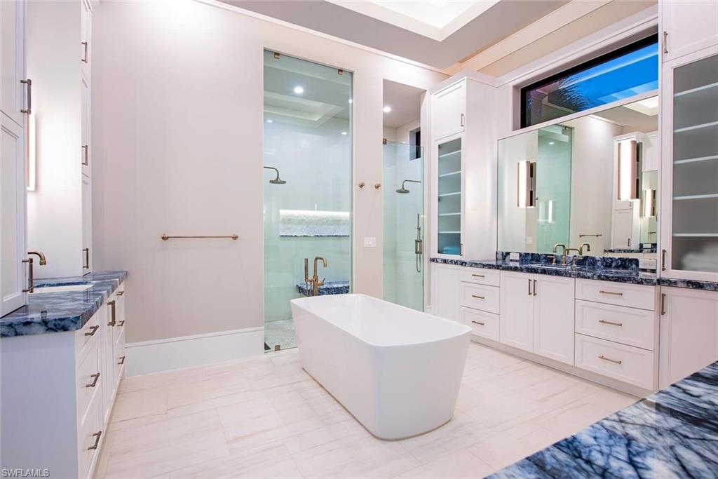 1456 Curlew Avenue Naples, FL 34102 - Photo 16 of 38 a spacious bathroom with a tub sink and mirror