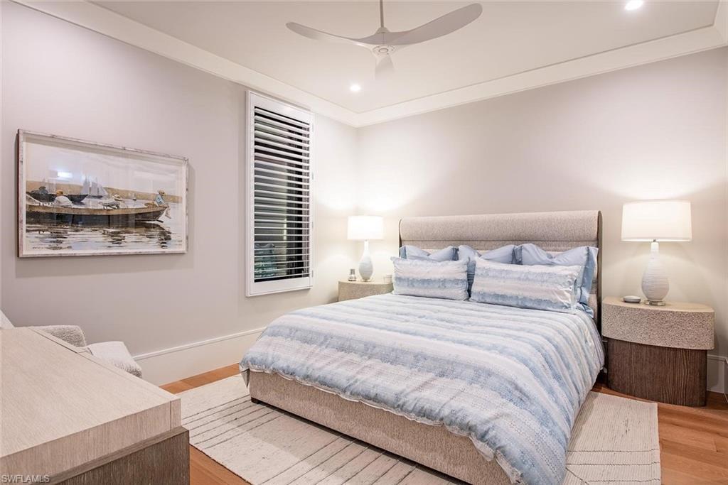 1456 Curlew Avenue Naples, FL 34102 - Photo 21 of 38 a bedroom with a bed and a painting on the wall