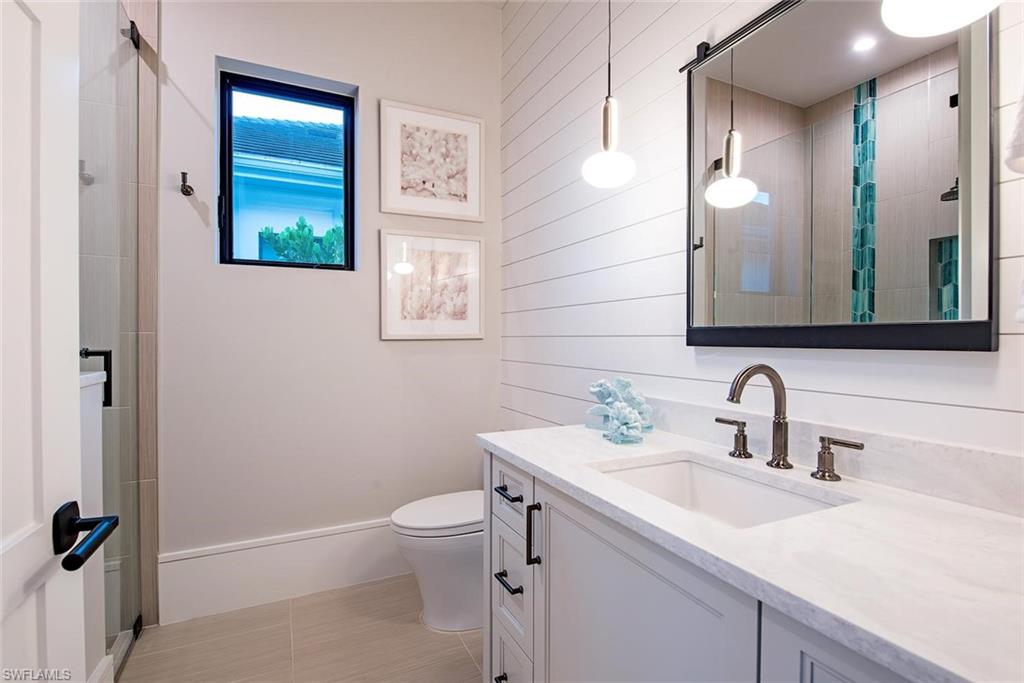 1456 Curlew Avenue Naples, FL 34102 - Photo 24 of 38 a bathroom with a sink a toilet and shower