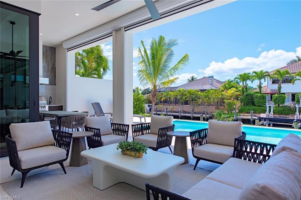 1456 Curlew Avenue Naples, FL 34102 - Photo 26 of 38 a outdoor living space with furniture and garden view