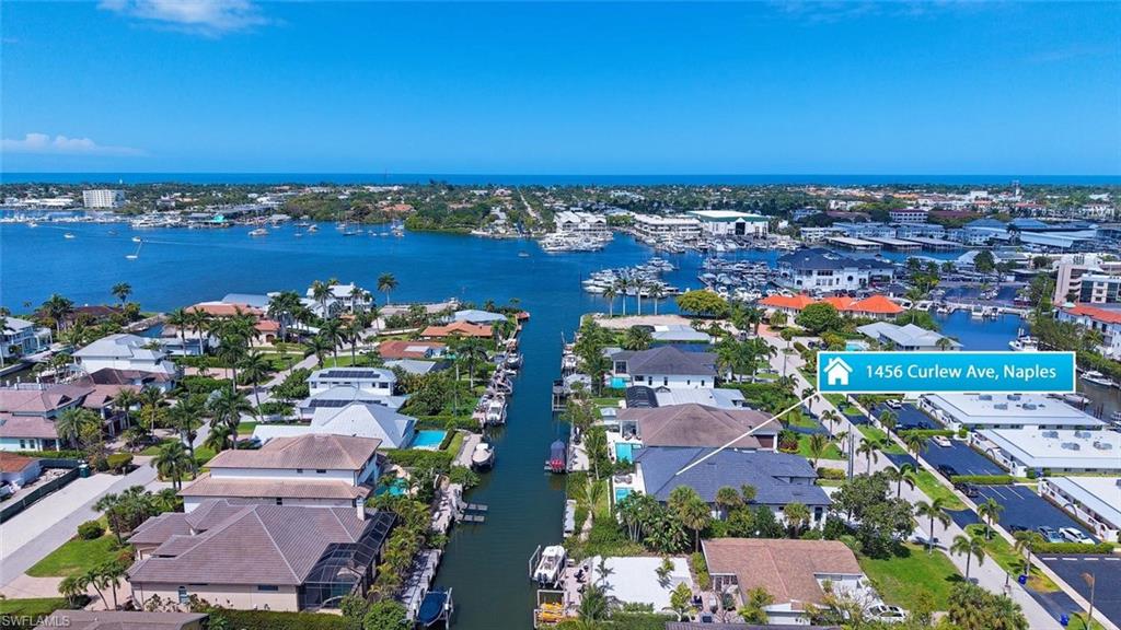 1456 Curlew Avenue Naples, FL 34102 - Photo 3 of 38 an aerial view of a city with lots of residential buildings and ocean view in back