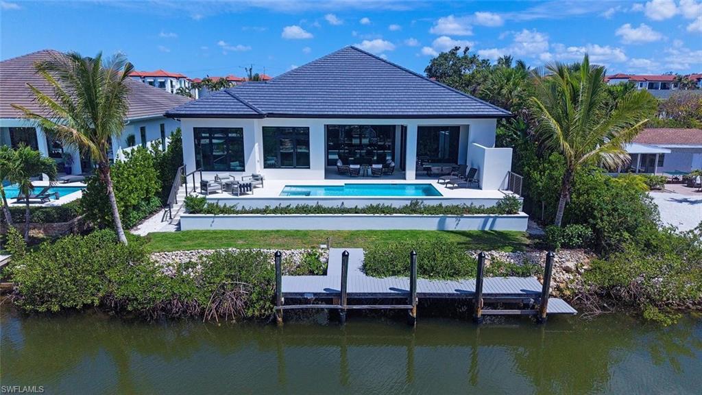 1456 Curlew Avenue Naples, FL 34102 - Photo 33 of 38 a house with swimming pool in front of it
