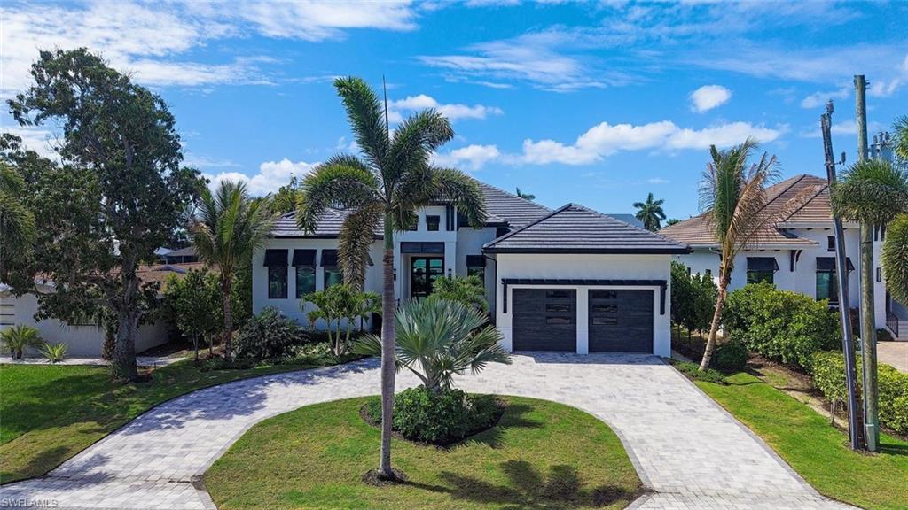1456 Curlew Avenue Naples, FL 34102 - Photo 34 of 38 a front view of a house with garden