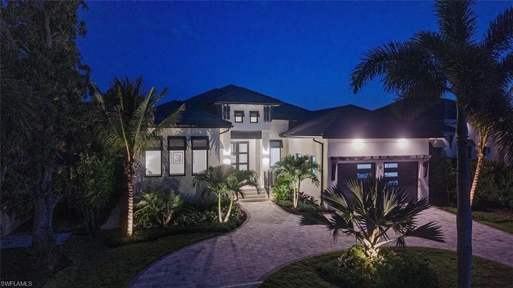 1456 Curlew Avenue Naples, FL 34102 - Photo 35 of 38 a front view of a house with a yard