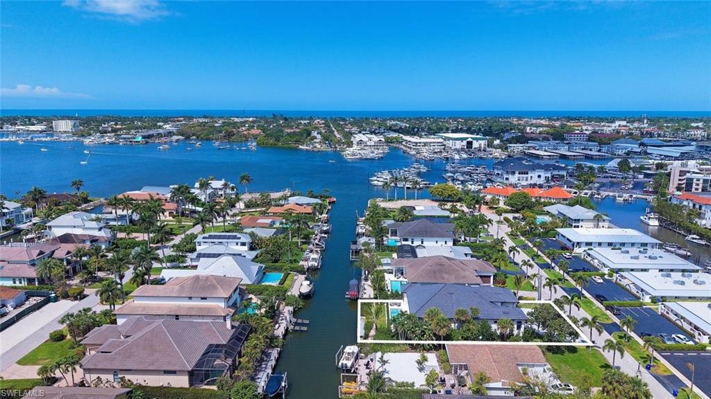 1456 Curlew Avenue Naples, FL 34102 - Photo 36 of 38 an aerial view of a city with lots of residential buildings ocean and mountain view in back