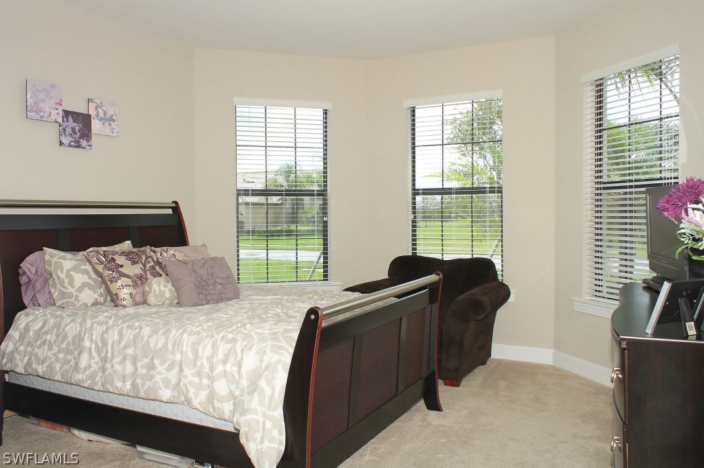 10874 Rutherford Road Fort Myers, FL 33913 - Photo 11 of 24 a bed sitting in a bedroom next to a window