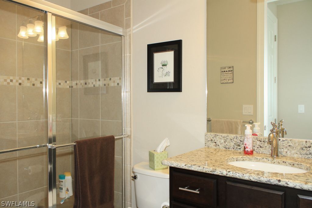 10874 Rutherford Road Fort Myers, FL 33913 - Photo 17 of 24 a bathroom with a granite countertop sink toilet and shower