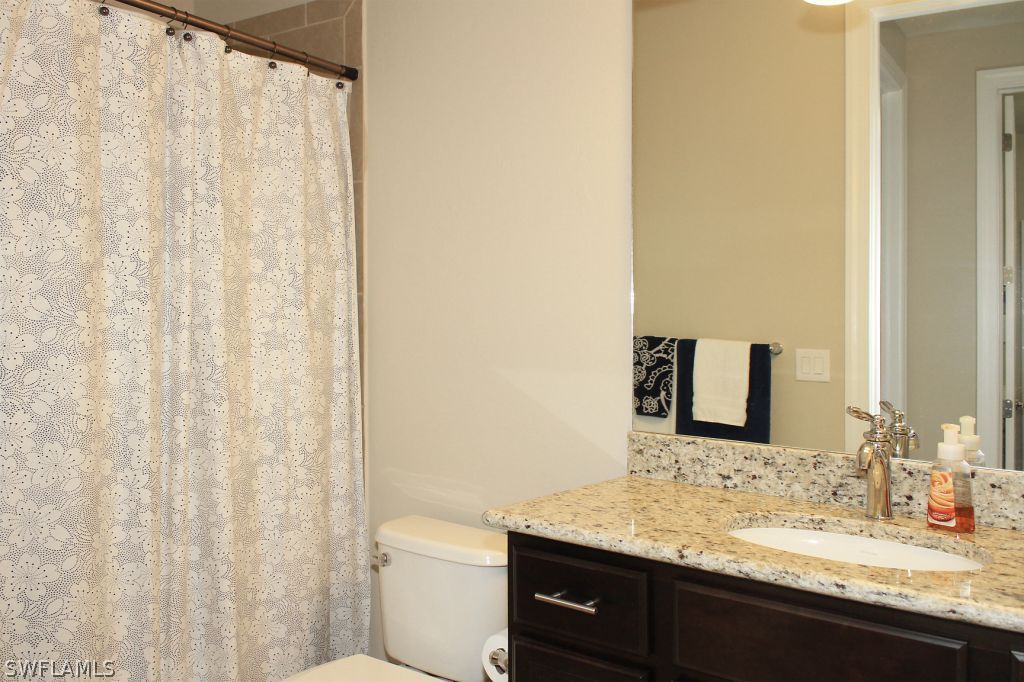 10874 Rutherford Road Fort Myers, FL 33913 - Photo 18 of 24 a bathroom with a granite countertop sink and a mirror