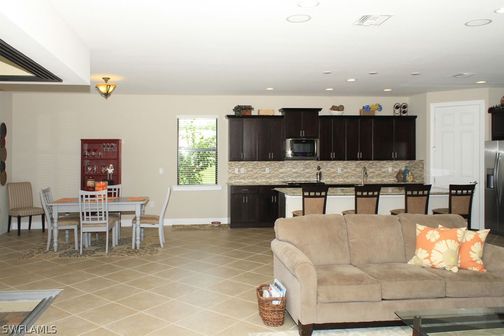 10874 Rutherford Road Fort Myers, FL 33913 - Photo 4 of 24 a living room with stainless steel appliances kitchen island granite countertop furniture and a kitchen view
