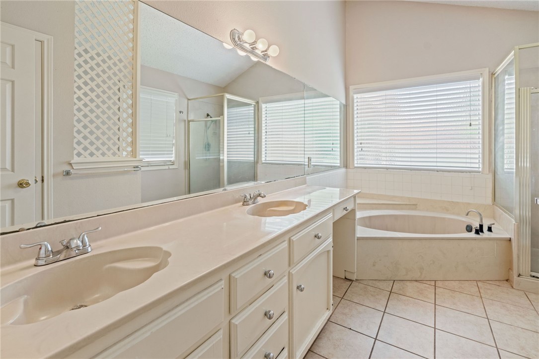 7209 Candy Ridge Road Corpus Christi, TX 78413 - Photo 20 of 24 a spacious bathroom with a tub sink and mirror