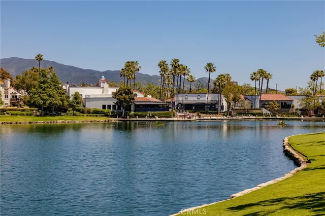 a view of a ocean with boats and trees in the background