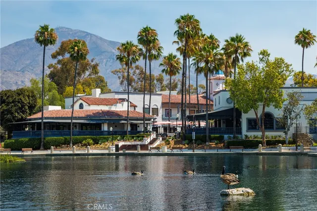 a front view of a house with outdoor seating area and swimming pool