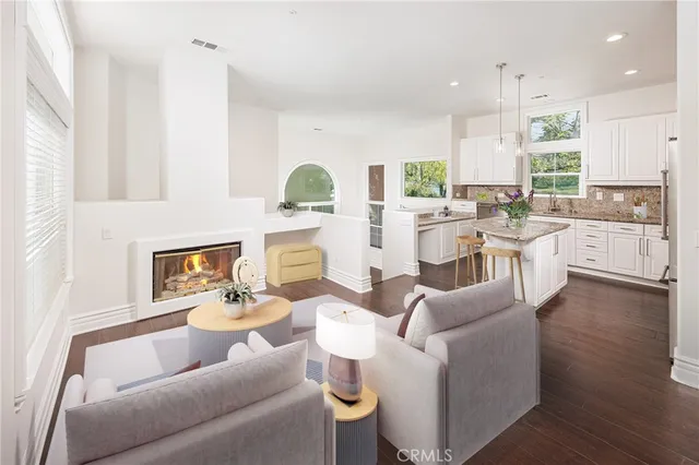 a living room with fireplace furniture and a large window