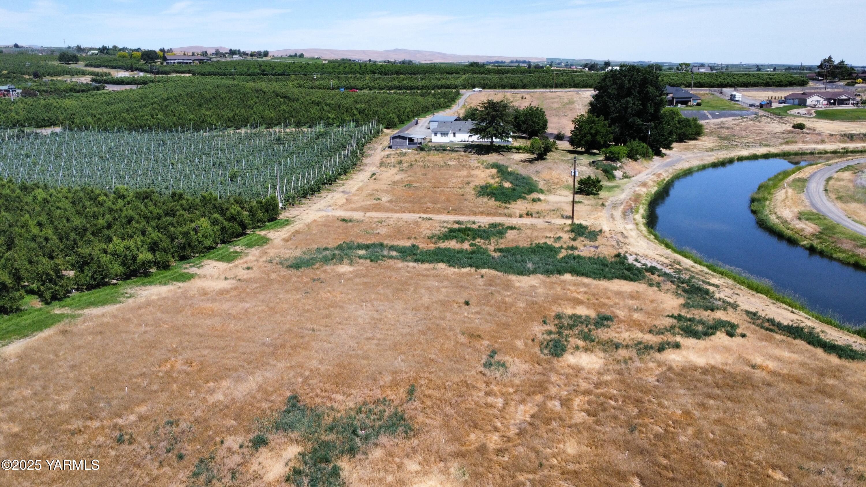 960 Knight Hill Road Zillah, WA 98953 - Photo 12 of 21 an aerial view of a house with garden space and lake view