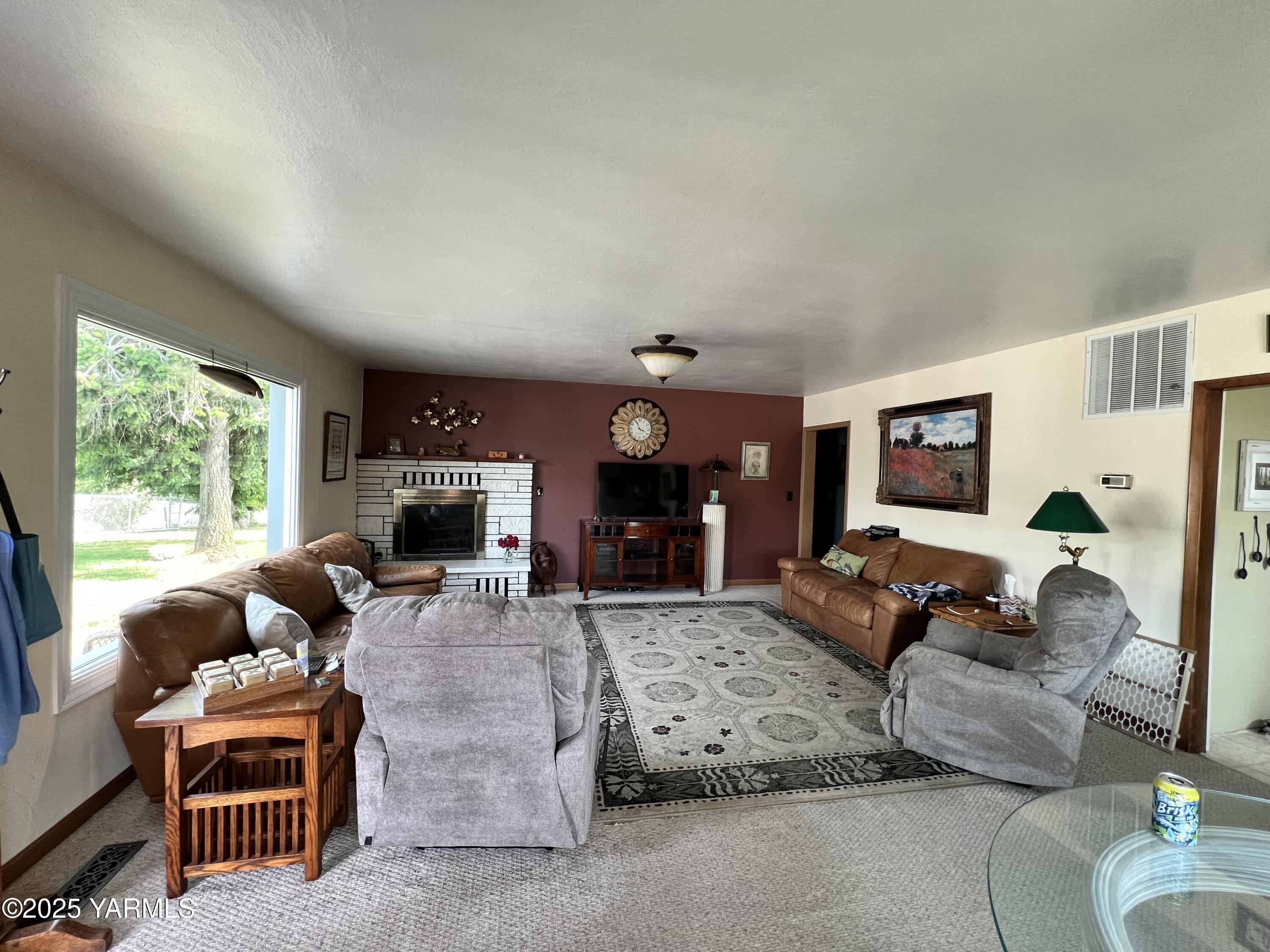 960 Knight Hill Road Zillah, WA 98953 - Photo 9 of 21 a living room with furniture fireplace and a large window