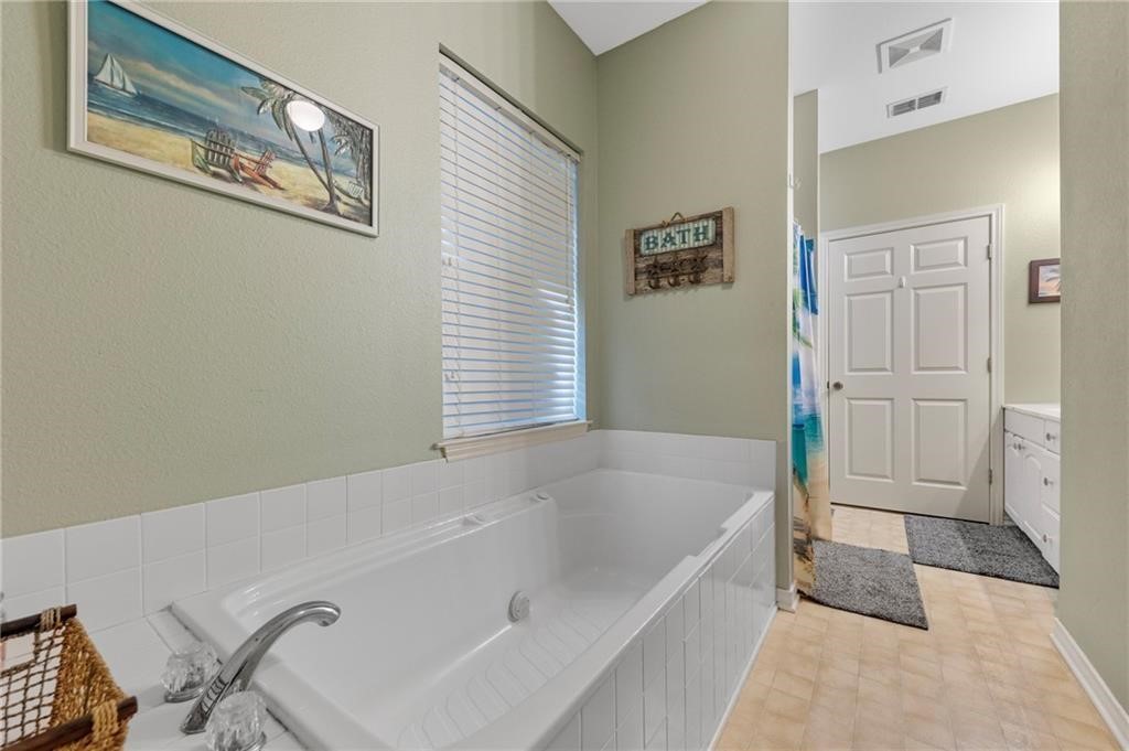 39 Front Street Rockport, TX 78382 - Photo 12 of 38 a bathroom with a bathtub and a shower