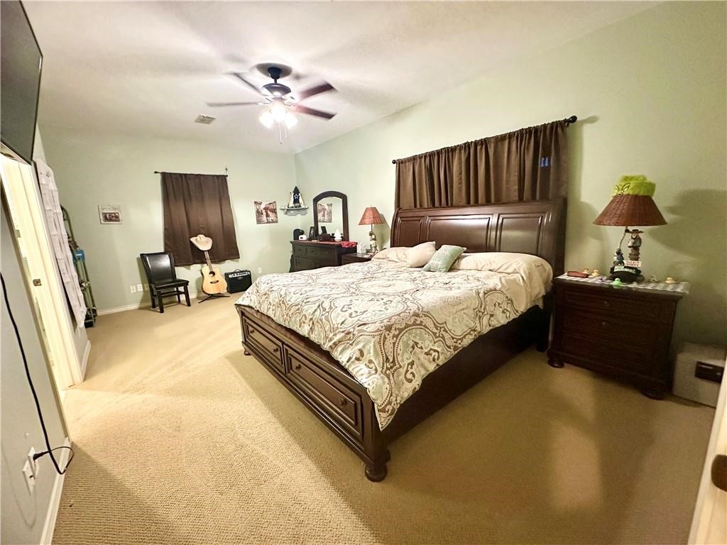 39 Front Street Rockport, TX 78382 - Photo 13 of 38 a bedroom with a bed and dresser with mirror