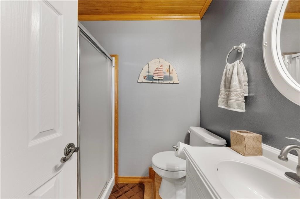 39 Front Street Rockport, TX 78382 - Photo 21 of 38 a bathroom with a sink mirror vanity and toilet