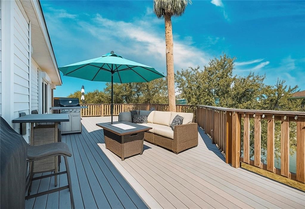 39 Front Street Rockport, TX 78382 - Photo 38 of 38 a view of balcony with wooden floor and outdoor seating