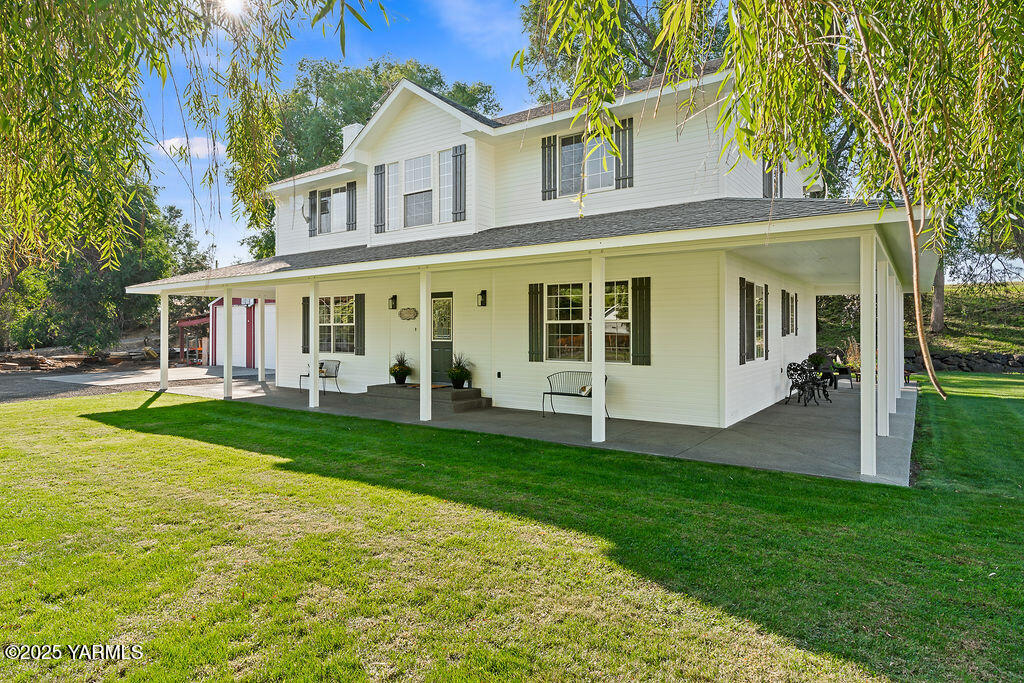 790 Cook Road Yakima, WA 98908 - Photo 3 of 46 a view of a white house with a big yard and potted plants