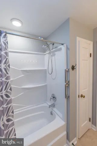 a bathroom with a shower and a bath tub