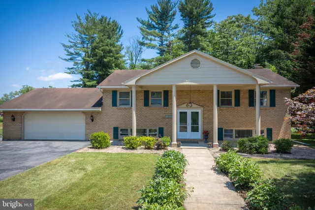 a front view of a house with a yard and porch