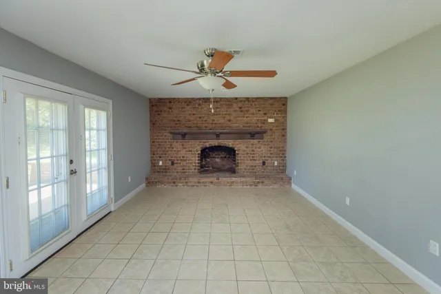 wooden floor fireplace and natural light in room
