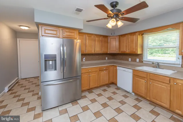 a kitchen with stainless steel appliances granite countertop a refrigerator sink and cabinets
