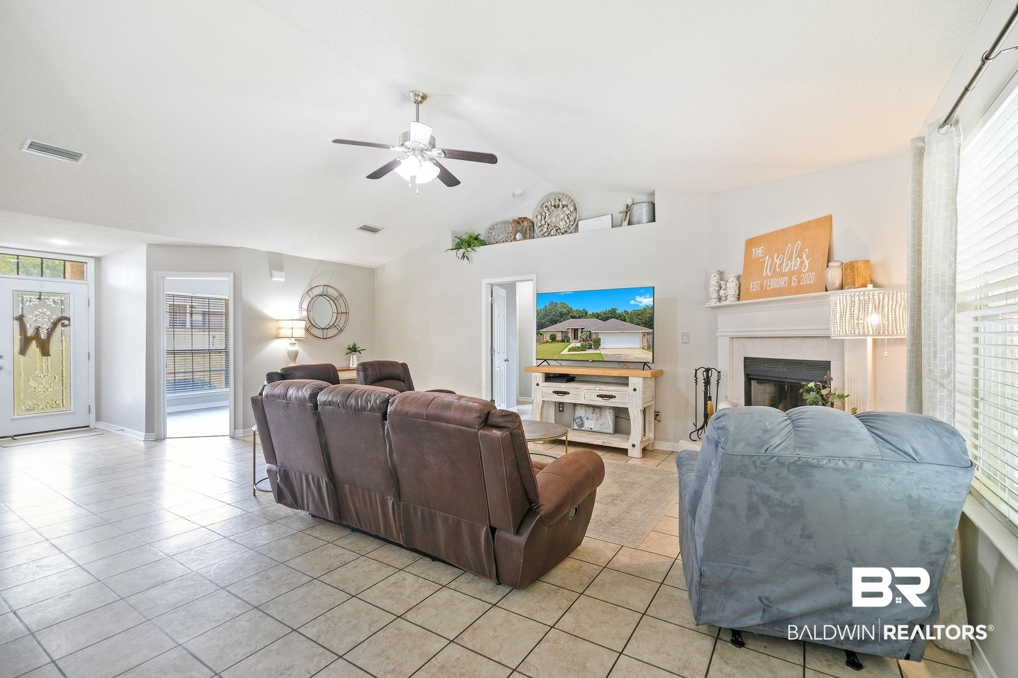28246 Turkey Branch Drive Daphne, AL 36526 - Photo 9 of 41 Living room with light tile patterned flooring, a fireplace, and plenty of natural light