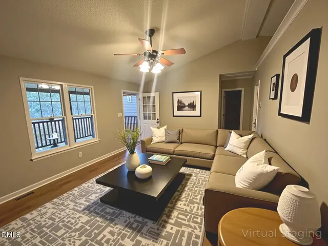 a living room with furniture and wooden floor