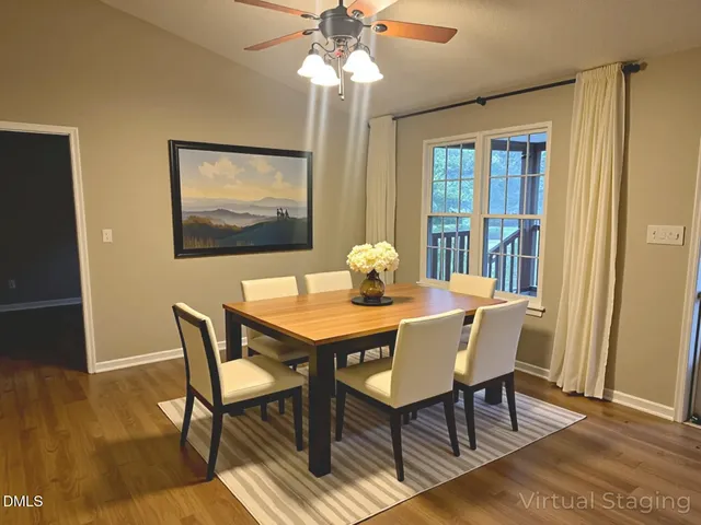 a view of a dining room with furniture wooden floor and chandelier