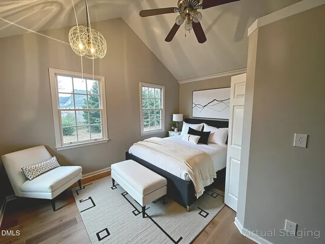 a bedroom with a bed a chandelier and couch