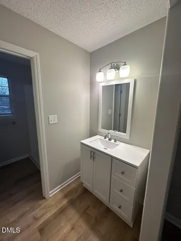 a room with a mirror and a sink