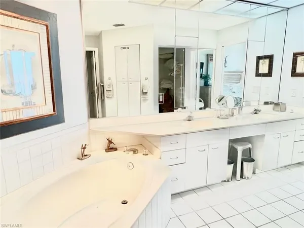 a bathroom with a double vanity sink mirror and
