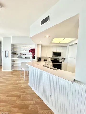 a kitchen with stainless steel appliances kitchen island granite countertop a sink counter space and cabinets