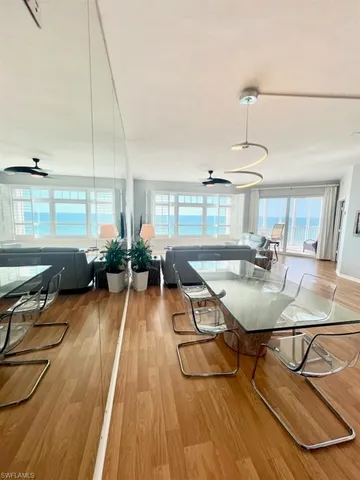 a room with lots of tables a chandelier and living room view