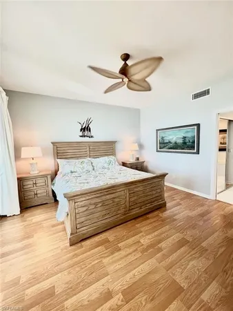 a spacious bedroom with a bed and a ceiling fan